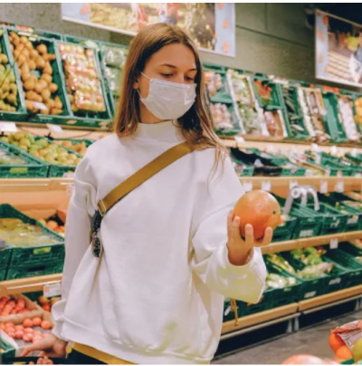 Girl in grocery store wearing a mask