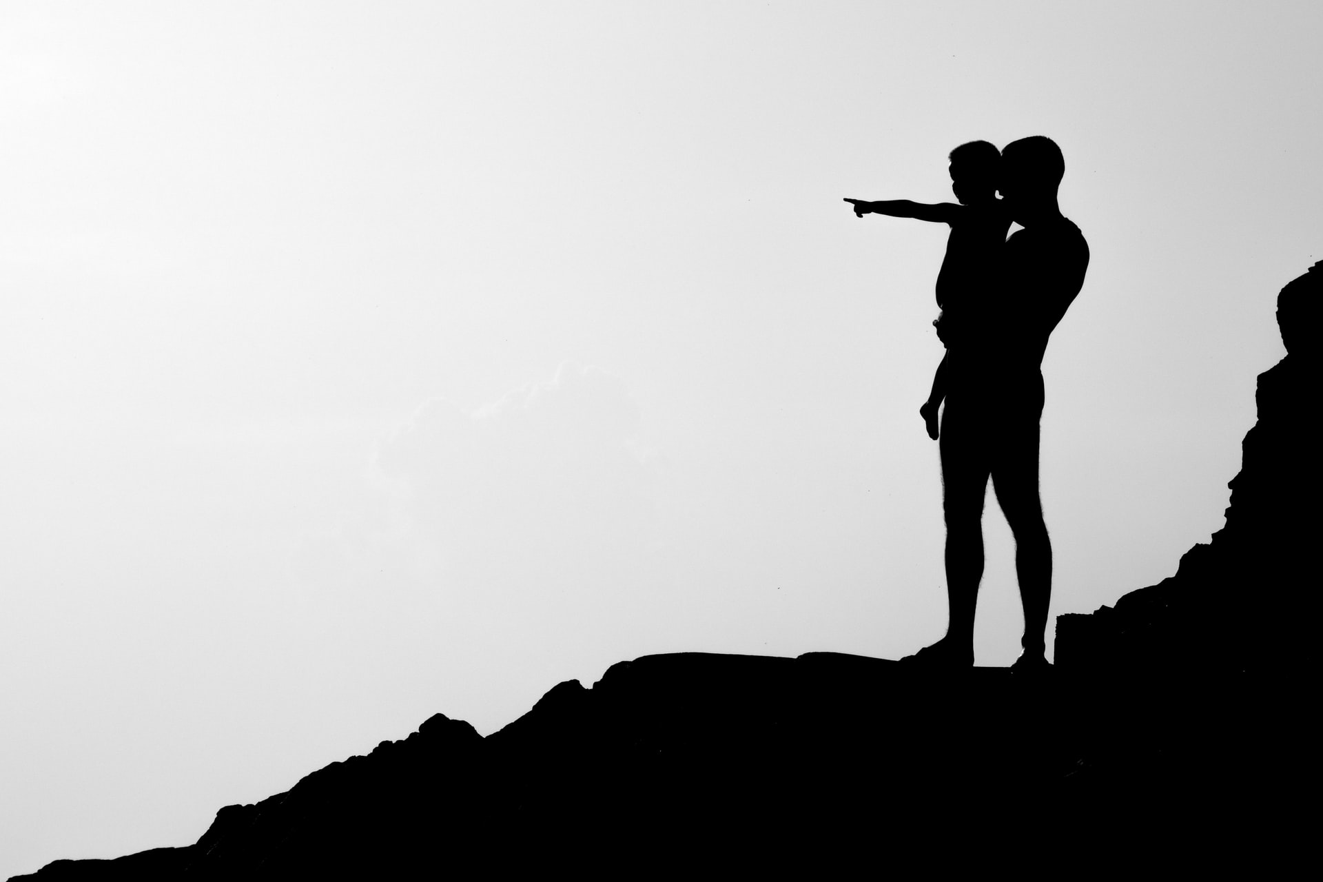 Silhouette of father holding child